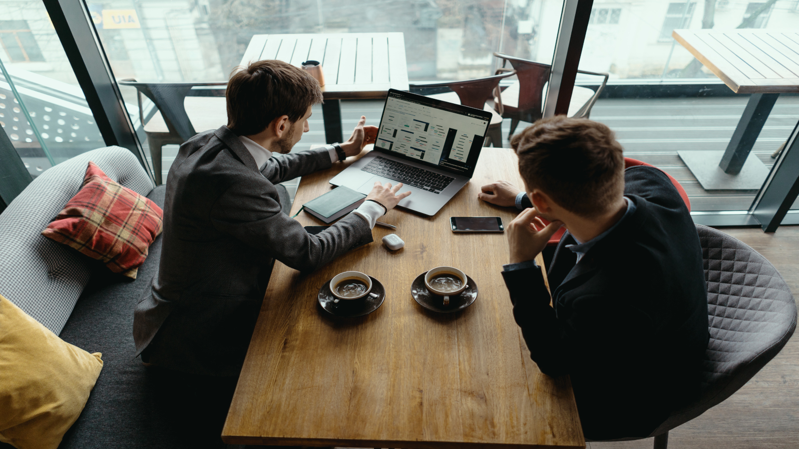 Two young businessman having a successful meeting at restaurant. Two young businessman having a successful meeting at restaurant.